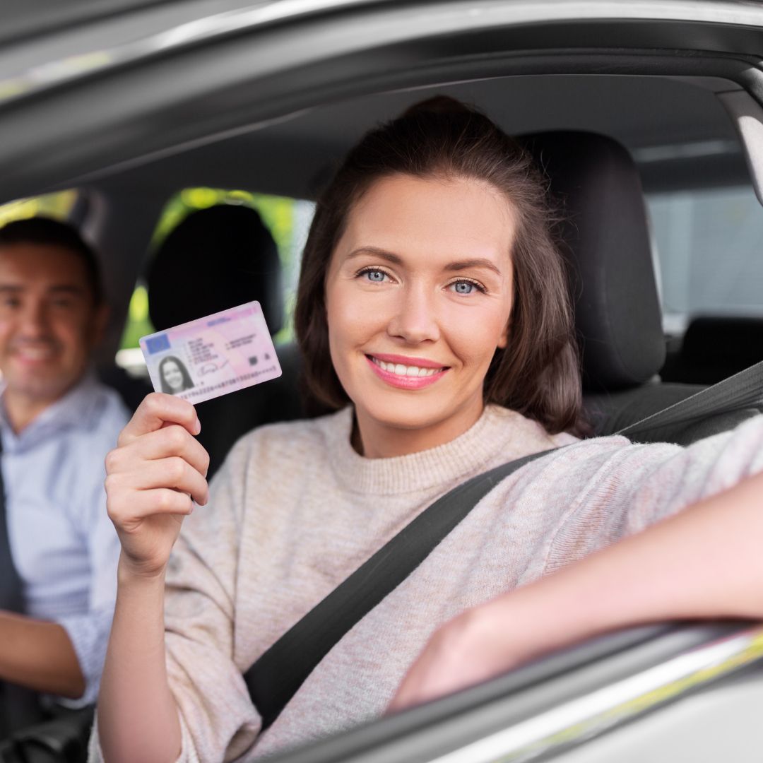 woman holding her id in the car