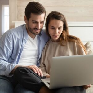 img of a couple looking at the computer