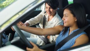 woman teaching daughter to drive