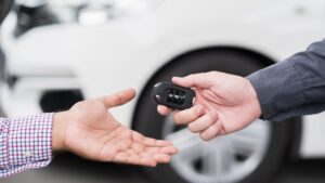 person handing over car keys