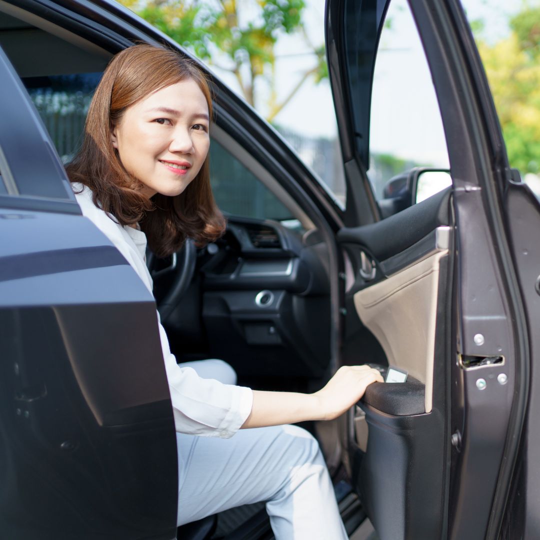 Woman smiling from her car