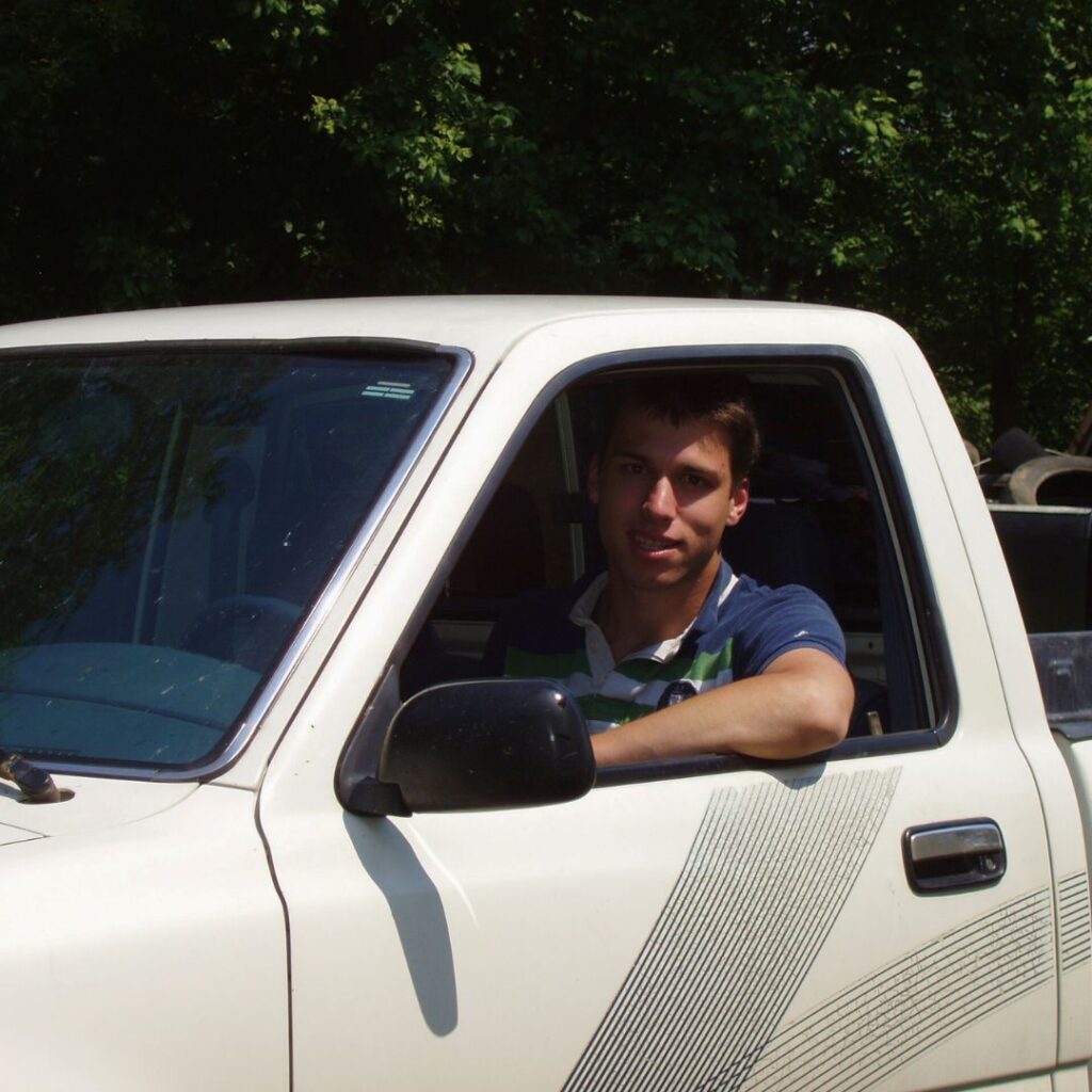 Teen boy smiling from driver's seat