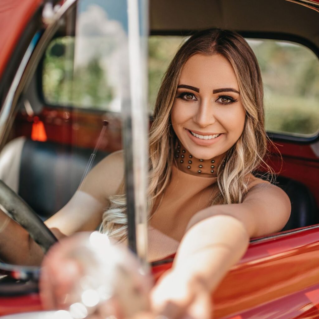 Young woman smiling from driver's seat