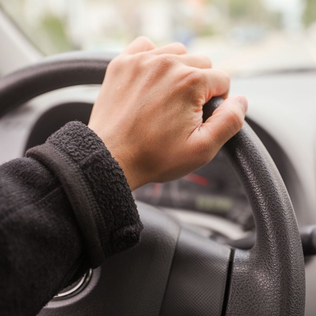 Hand on steering wheel