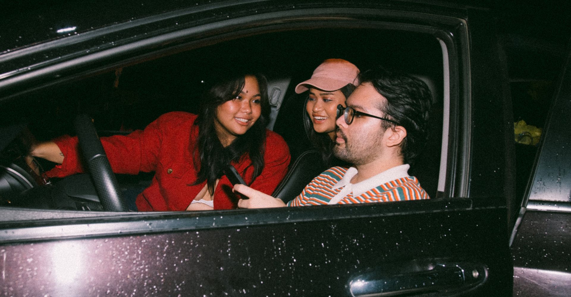 Group of friends chatting in idle car